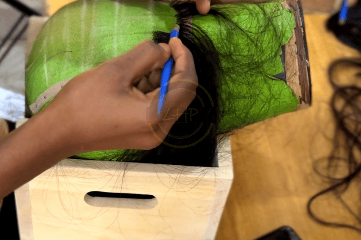 Hand ventilating lace in Lagos studio